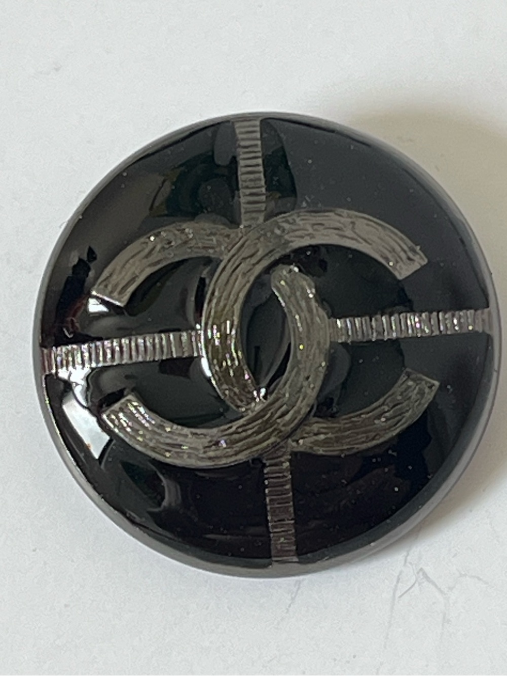 One Chanel black, silver CC logo metal measurement in photos
